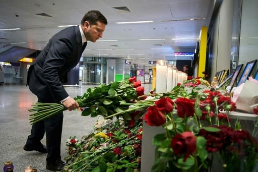 Ukraine's President Volodymyr Zelensky, pictured on January 9, 2020 in a presidential press handout photo placing flowers at a memorial for the victims of the Ukraine International Airlines crash in Tehran, has toughened his stance on Iran