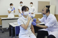 A medical worker of Tokyo Medical Center receives a booster shot of the Pfizer COVID-19 vaccine Wednesday, Dec. 1, 2021 in Tokyo. Japan has started administering the booster shots to health care workers on Wednesday. (Kyodo News via AP)