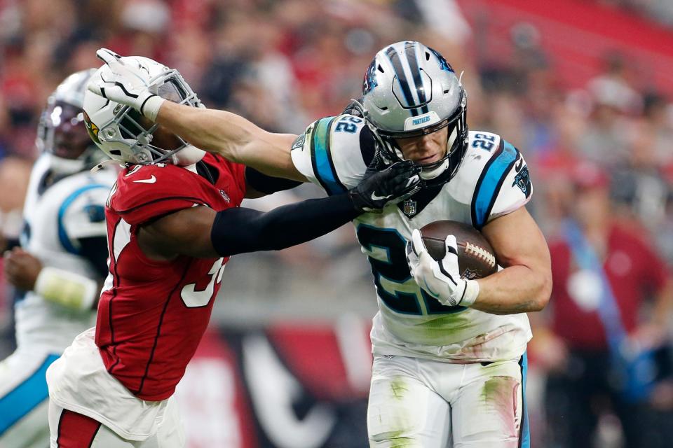 Carolina Panthers running back Christian McCaffrey (22) breaks away from Arizona Cardinals free safety Jalen Thompson, left, during the first half of an NFL football game Sunday, Nov. 14, 2021, in Glendale, Ariz. (AP Photo/Ralph Freso)