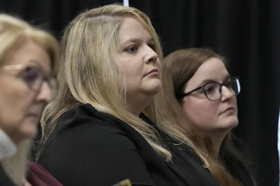 Caroline Hunt, cener, and Tessa Henry, right, with the Attorney General's office, listen during a clemency hearing for death row inmate Scott Eizember, Wednesday, Dec. 7, 2022, in Oklahoma City. Eizember was convicted in the shotgun slayings of an elderly couple in eastern Oklahoma in 2003. (AP Photo/Sue Ogrocki)