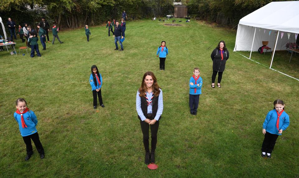 Britain's Catherine, Duchess of Cambridge (C) poses for a photograph with members of the Beaver Scouts during her visit to a Scout Group in Northolt, northwest London on September 29, 2020, where she joined Cub and Beaver Scouts in outdoor activities. - The Duchess learned how the Scouts have adapted during the COVID-19 pandemic, and continued Scouting sessions and online activities. (Photo by Daniel LEAL-OLIVAS / various sources / AFP) (Photo by DANIEL LEAL-OLIVAS/AFP via Getty Images)