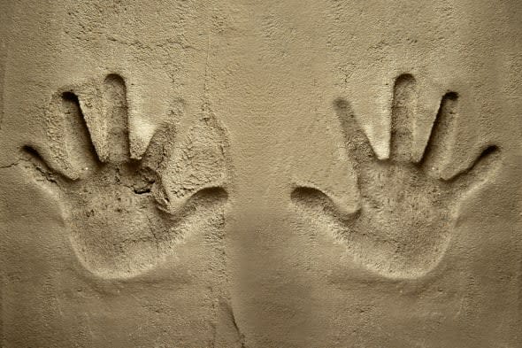 both hands print on cement mortar wall with shadow relief