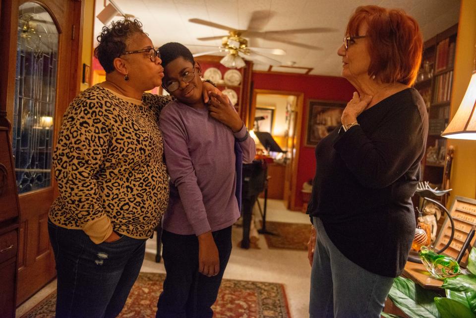 Kim Boyd embraces her son, Ty, as she recounts a story to his piano teacher Rita Winter in Martin, Tenn., on Monday, Oct. 16, 2023. Boyd worries that if Tennessee rejects federal funding for education, those with disabilities could suffer as a result.