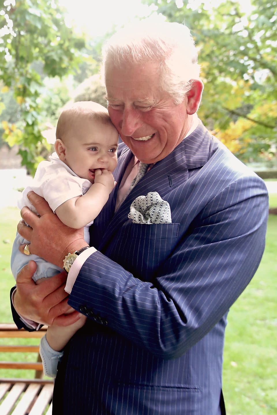 <p>Prince Charles holding baby Prince Louis.</p>