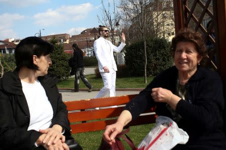 Student and 2017 presidential candidate Luka Maksimovic, 25, walks in a park as his alter ego 'Ljubisa "Beli" Preletacevic' a parody of the worst politician in the Balkans, in the town of Mladenovac, Serbia, March 20, 2017. Picture taken March 20, 2017. REUTERS/Djordje Kojadinovic