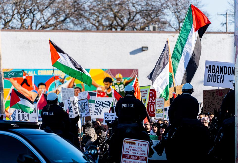 People protest outside the Wisconsin Black Chamber of Commerce as President Joe Biden speaks inside on Wednesday in Milwaukee.