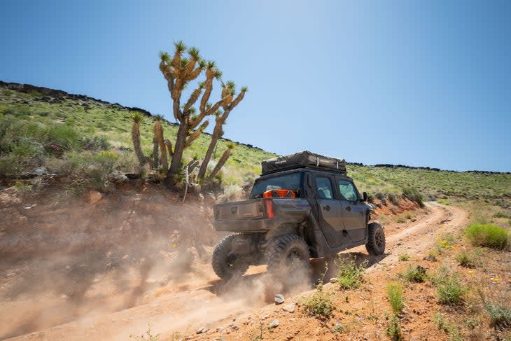 The Polaris Xpedition driving on a gravel road