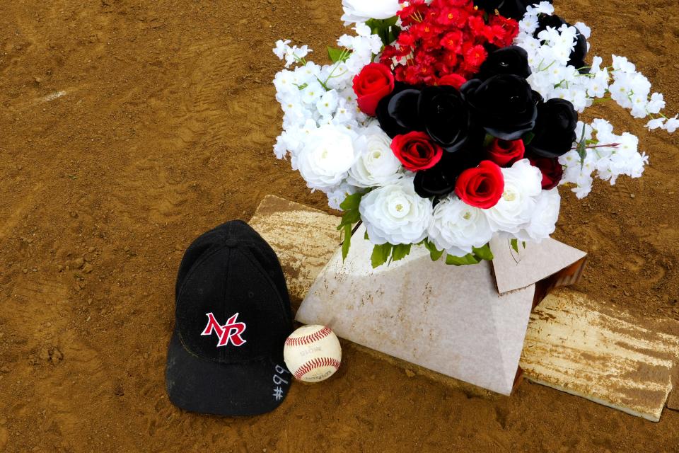 A baseball cap with the number #99 sits at the pitcher’s mound at the NRYSA Baseball/Softball Complex behind Monroe Elementary, Friday, where Clayton Doerman played ball on the New Richmond Riverbats team.