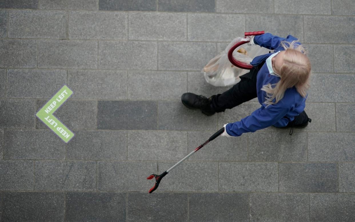  Cleaning personnel wears a face mask on July 14, 2020 in Liverpool, United Kingdom. The UK government has announced that people entering shops will be required to wear a face mask by law from July 24. Scientists have also predicted a 'worse case scenario' of a second wave of Covid-19 related deaths between 24,500 and 251,000 in hospitals alone in a report requested by the UK's chief scientific adviser, Sir Patrick Vallance - Christopher Furlong/Getty 