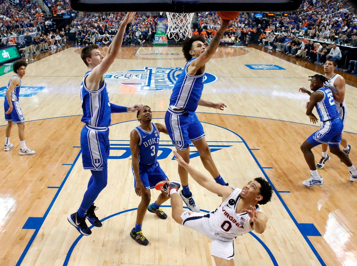 Duke’s Dereck Lively II (1) blocks the shot by Virginia’s Kihei Clark (0) during Duke’s 59-49 victory over Virginia to win the ACC Men’s Basketball Tournament in Greensboro, N.C., Saturday, March 11, 2023.