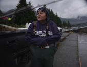 Terrie Brigham of the Confederated Tribes of the Umatilla stands on the banks of the Columbia River, where her family has used dip nets to fish from scaffolds for generations, on Friday, June 17, 2022, in Cascade Locks, Ore. Brigham's grandfather erected the family's scaffolds in the 1950s. (AP Photo/Jessie Wardarski)