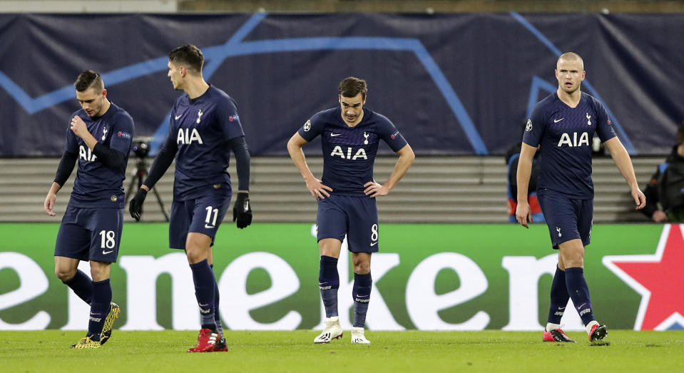 Tottenham's Giovani Lo Celso, Erik Lamela, Harry Winks and Eric Dier, from left, stand disappointed after they received the opening goal during the Champions League round of 16, 2nd leg soccer match between RB Leipzig and Tottenham Hotspur in Leipzig, Germany, Tuesday, March 10, 2020. (AP Photo/Michael Sohn)