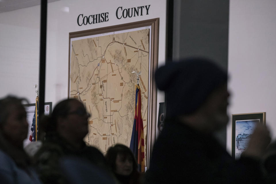 FILE - Members of the public attend Cochise County Board of Supervisors meeting to provide feedback on the proposed transfer of election functions and duties to the county recorder on Feb. 14, 2023, in Bisbee, Ariz. Cochise County, where leaders have embraced voting machine conspiracies, voted Tuesday, April 25, 2023, to hired an elections director who has promoted the false claims that fraud cost former President Donald Trump's re-election in 2020. (AP Photo/Alberto Mariani, File)