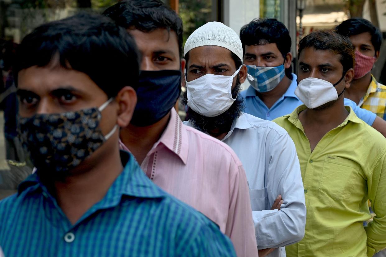 <p>People wait in a queue to get a Rapid Antigen Testing (RAT) at a roadside market following restrictions imposed by the state government</p> (AFP via Getty Images)