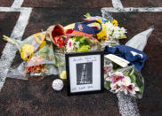 A makeshift memorial was created on home plate Orange Coast College baseball field in Costa Mesa, Calif. on Sunday, Jan. 26, 2020 for Orange Coast College baseball Coach Altobelli, his wife Keri and daughter Alyssa who were killed in the helicopter crash that also killed former Lakers star Kobe Bryant. (Leonard Ortiz/The Orange County Register via AP)