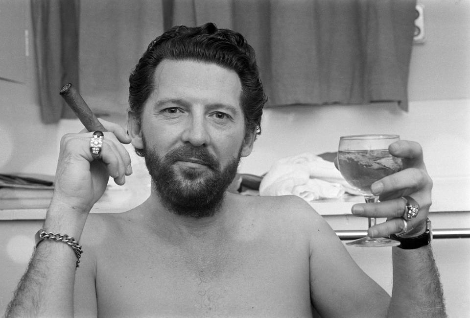 American musician and singer Jerry Lee Lewis pictured with cigar and drinking glass backstage at the Palladium in London on 24th April 1972. (Photo by Steve Wood/Daily Express/Hulton Archive/Getty Images)