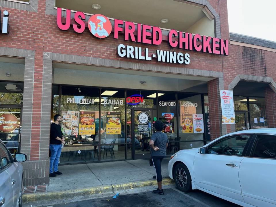 US Fried Chicken co-owner Mohammed Alweesi chats with a customer outside the restaurant’s Albemarle Road location. Heidi Finley/CharlotteFive