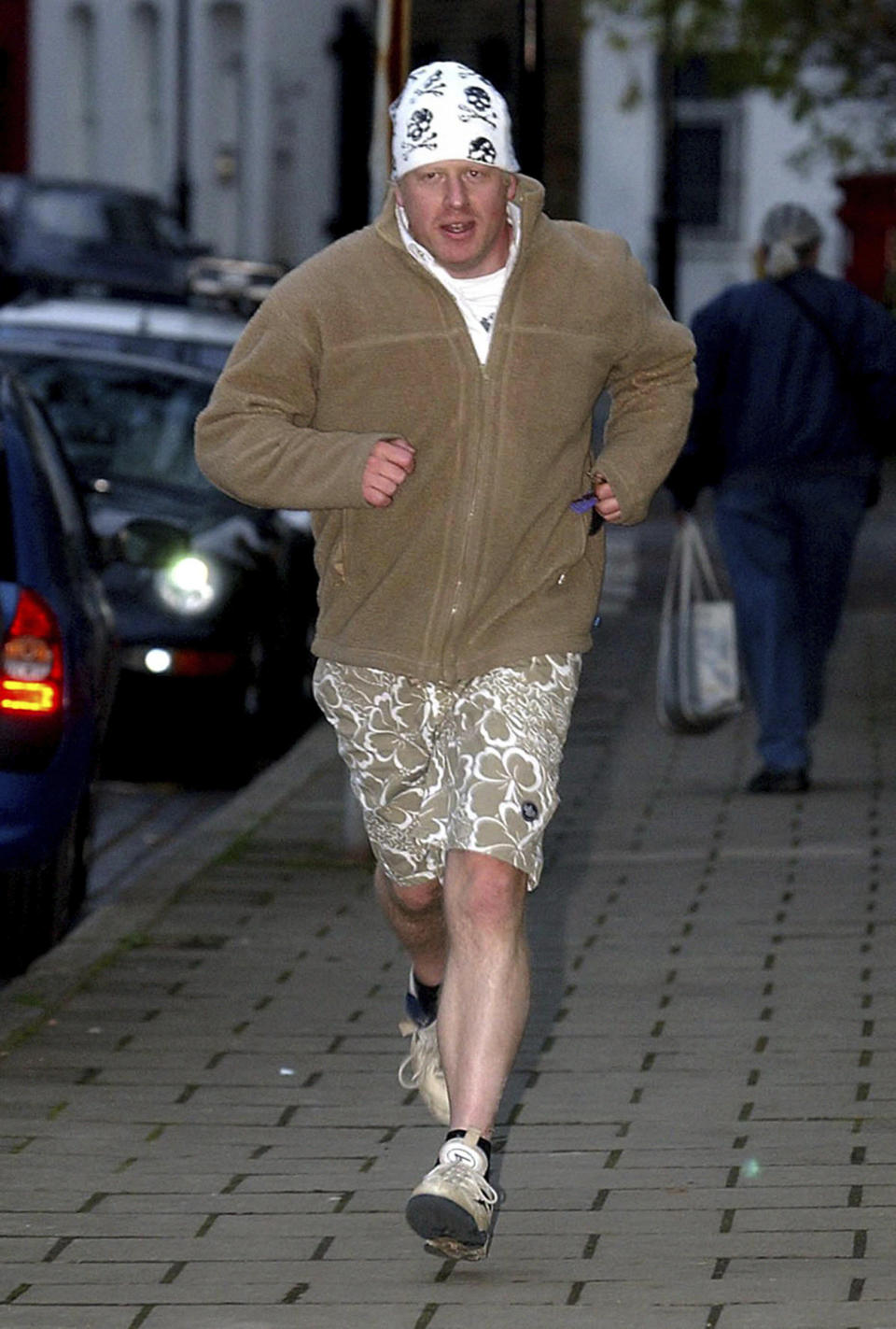 FILE - Boris Johnson comes back from a run just after he was sacked as the shadow arts minister of the Conservative party on Nov. 15, 2004. For Boris Johnson, facts have always been flexible. The British prime minister's career is littered with doctored quotes, tall tales, exaggerations and mistruths. When called out, he has generally offered an apologetic shrug or a guilty grin, and moved on. At least until now. Revelations that the prime minister and his staff partied while Britain was under coronavirus restrictions has provoked public outrage. (Chris Young/PA via AP, File)