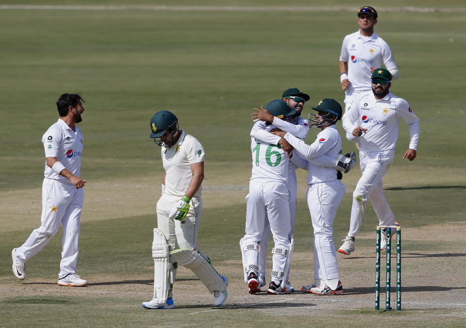 Pakistan's Mohammad Rizwan, 16, is congratulated by teammates after he took the catch of South Africa's Dean Elgar, second left, during the third day of the first cricket test match between Pakistan and South Africa at the National Stadium, in Karachi, Pakistan, Thursday, Jan. 28, 2021. (AP Photo/Anjum Naveed)