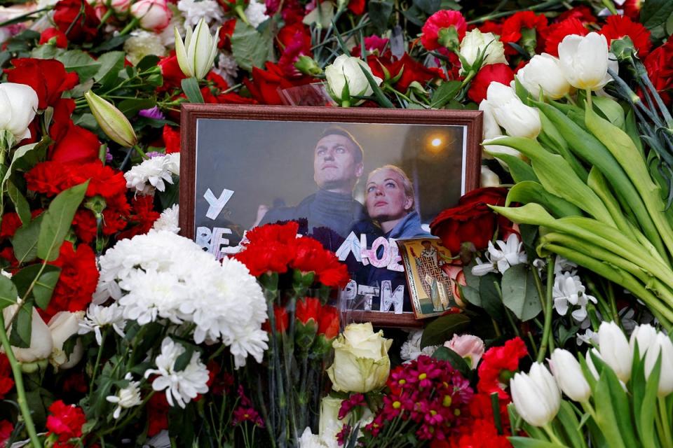 A photograph of the Navalnys is placed amid flowers on the Moscow grave of the Russian opposition leader (Reuters)