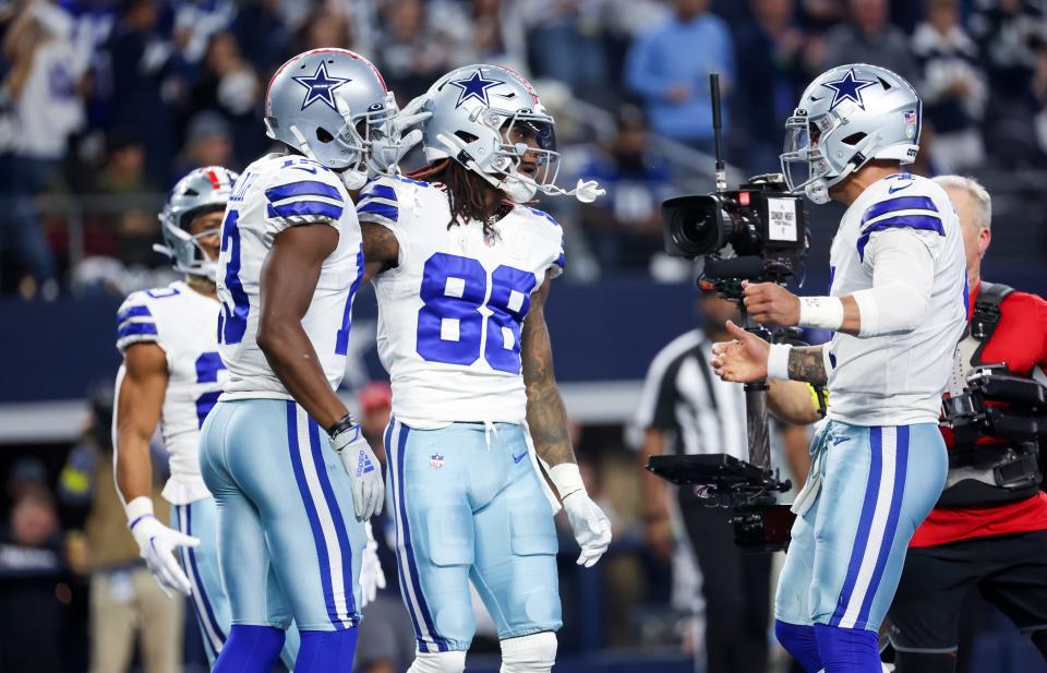 Dallas Cowboys wide receiver CeeDee Lamb (88) celebrates with quarterback Dak Prescott (4) after scoring a touchdown against the Indianapolis Colts at AT&T Stadium.