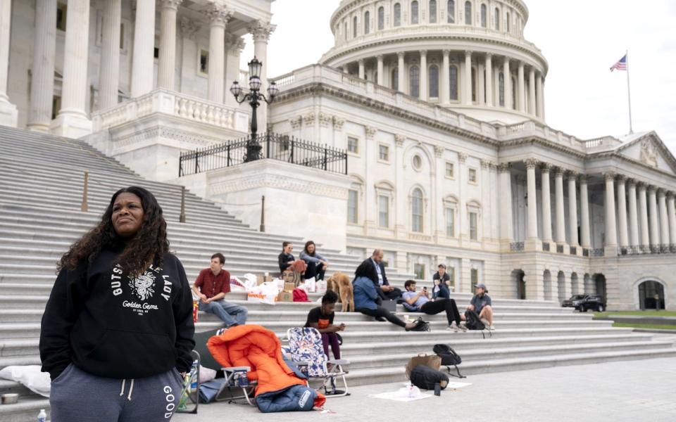 Representative Cori Bush, a Democrat from Missouri, left, joined by Congressional staffers and activists, protests the expiration of the eviction moratorium outside of the U.S. Capitol in Washington, D.C., U.S., on Saturday, July 31, 2021. - Bloomberg