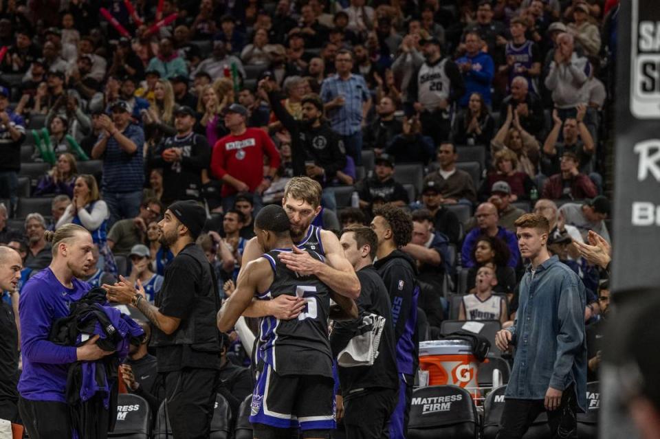 Sacramento Kings center Domantas Sabonis (10) hugs teammate De’Aaron Fox (5) after recording his 54th consecutive double-double in an NBA game against the Philadelphia 76ers on Monday at Golden 1 Center. It is the longest single-season streak since the ABA-NBA merger.