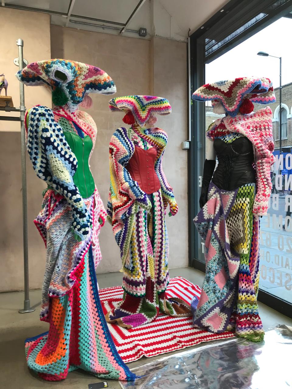 Francesco Colucci styles the windows of Traid by repurposing donated clothes and glitzy fabrics.