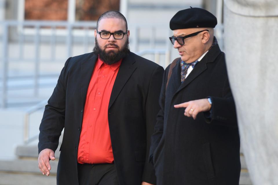 Former Paterson police officer Jonathan Bustios, on left, leaves the Federal District Courthouse in Newark, with his attorney Michael Koribanics, after pleading guilty to charges of extortion and conspiracy to deprive persons of their human rights on Tuesday, December 18, 2018.