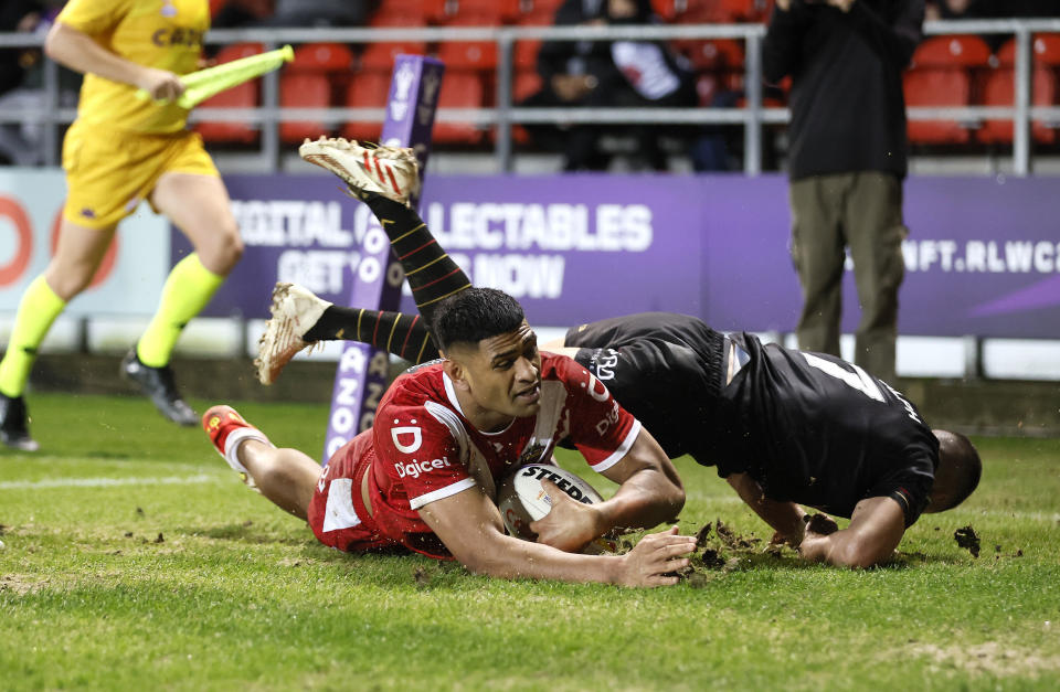 Tonga's Daniel Tupou scores a try during the Rugby League World Cup group D match between Wales and Tonga at the Totally Wicked Stadium, St Helens, England, Monday Oct. 24, 2022. (Richard Sellers/PA via AP)