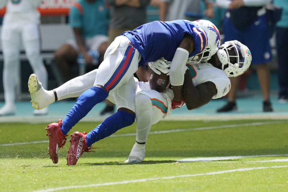 Buffalo Bills safety Jaquan Johnson (4) takes Miami Dolphins wide receiver Tyreek Hill (10) during the first half of an NFL football game, Sunday, Sept. 25, 2022, in Miami Gardens, Fla. (AP Photo/Rebecca Blackwell)