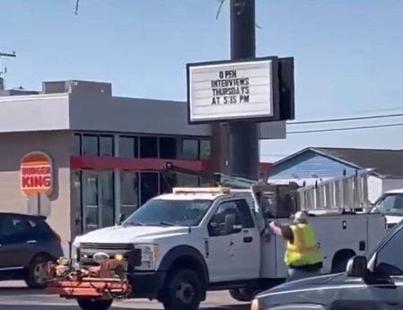 A still photo from a video shared on social media shows an armed bystander confront a carjacking suspect shortly before the truck struck the bystander, killing him in Lumberton last month. John Lecompte, 38, of Fayetteville, was identified by police as the bystander.