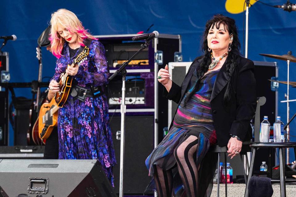 <p>Erika Goldring/Getty</p> Nancy Wilson and Ann Wilson of Heart perform in New Orleans in April 2024