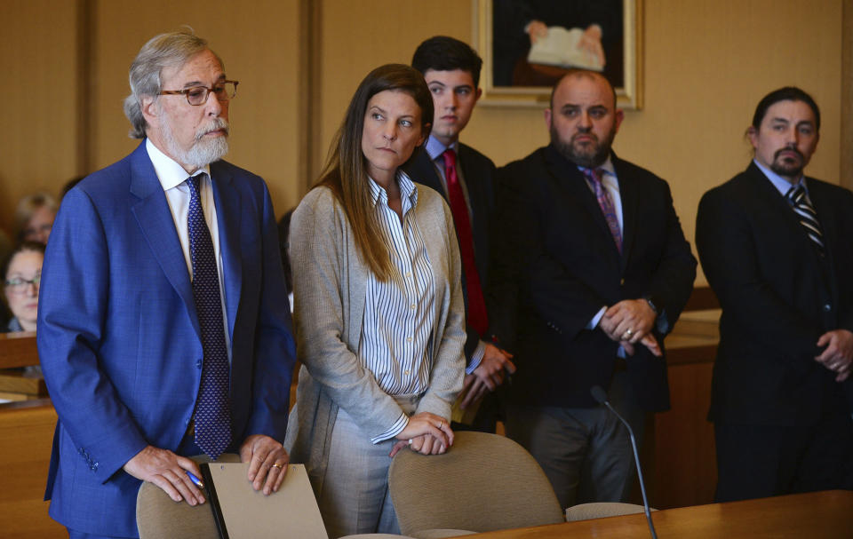 Michelle Troconis, center, listens as a member of her legal team Andrew Bowman, left, addresses the court during a hearing at Stamford Superior Court, Tuesday, June 11, 2019 in Stamford, Conn. Fotis Dulos, and his girlfriend, Michelle Troconis, have been charged with evidence tampering and hindering prosecution in the disappearance of his wife Jennifer Dulos. The mother of five has has been missing since May 24. (Erik Trautmann/Hearst Connecticut Media via AP, Pool)