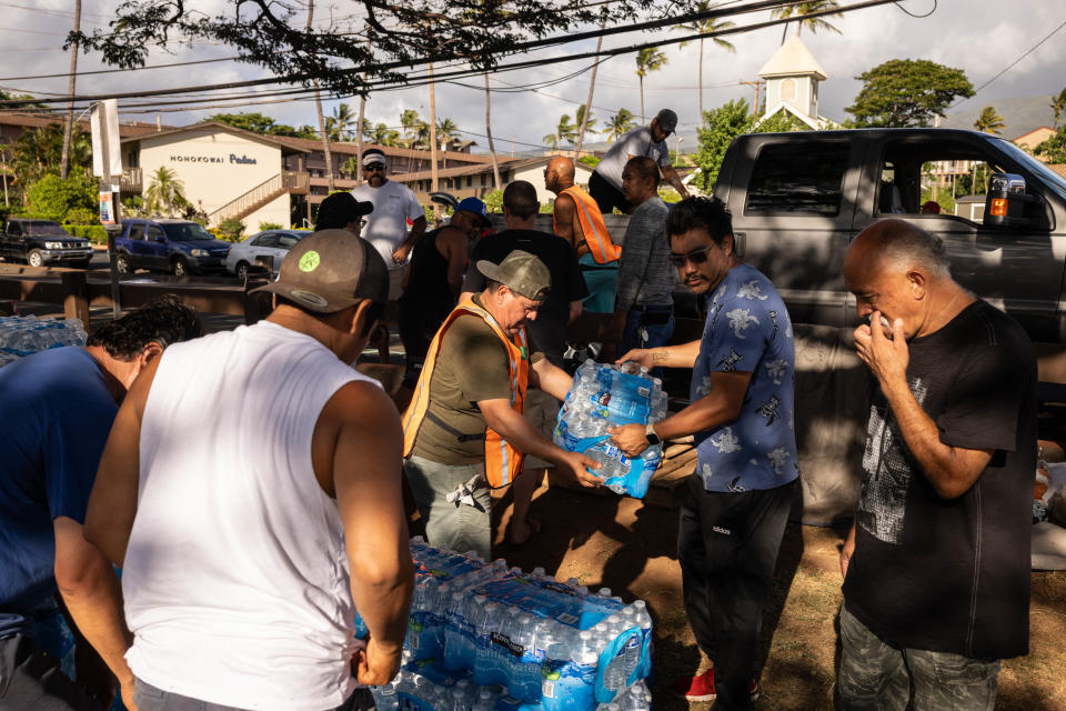 Volunteers unload donations at a distribution center for those affected by the Maui fires at Honokawai Beach Park in Napili-Honokowai, west of Maui, Hawaii, August 14, 2023.