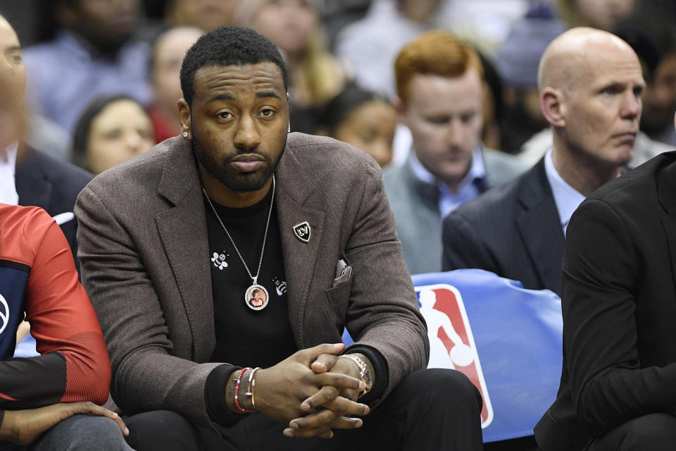 Washington Wizards guard John Wall sits on the bench during the first half of a game the day after he reportedly fell at his home. (AP Photo/Nick Wass)