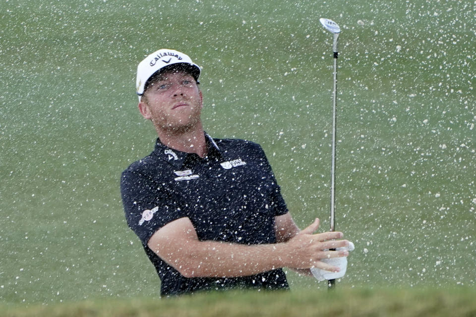 Talor Gooch hits from a bunker onto the 16th green during the final round of the LIV Golf Team Championship at Trump National Doral Golf Club, Sunday, Oct. 30, 2022, in Doral, Fla. (AP Photo/Lynne Sladky)