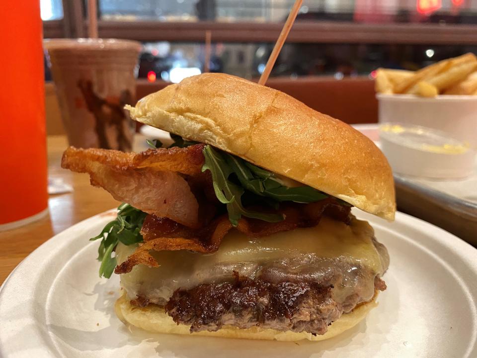 The Schnipper's Classic at Schnipper's in New York City is topped with caramelized onions, crispy bacon, arugula and "Schnipper sauce."
