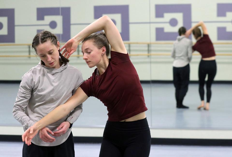 Dancers Stephanie Roston, left, and Anna Baugham, right, explore ways to convey the struggles of memory loss during Dominic Moore-Dunson's first rehearsal for "The Remember Balloons" at Guzzetta Hall Dec. 7 in Akron.