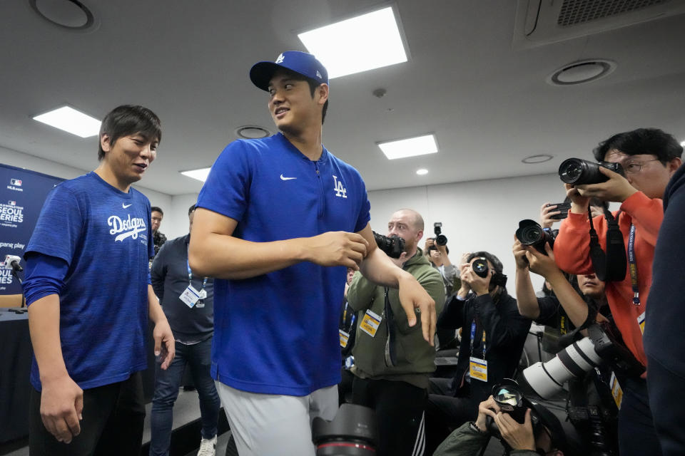 FILE - Los Angeles Dodgers' Shohei Ohtani, right, and his interpreter, Ippei Mizuhara, leave after a news conference ahead of a baseball workout at Gocheok Sky Dome in Seoul, South Korea, March 16, 2024. Mizuhara has been fired by the Dodgers following allegations of illegal gambling and theft. (AP Photo/Lee Jin-man, File)