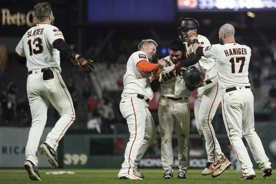 San Francisco Giants' LaMonte Wade Jr., third from right, celebrates with teammates after hitting the game-winning RBI single against the Cleveland Guardians during the 10th inning of a baseball game Monday, Sept. 11, 2023, in San Francisco. (AP Photo/Godofredo A. Vásquez)