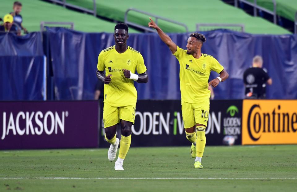 Nashville SC midfielder Hany Mukhtar (right) celebrates with defender Jalil Anibaba after a goal against Chicago in 2021.