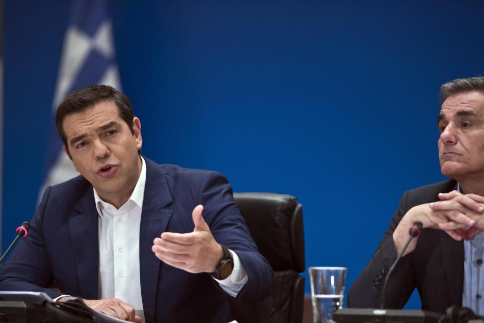 Greek Prime Minister Alexis Tsipras, left, announces bailout relief measures, next to Greek Financial Minister Euklid Tsakalotos, during a press conference, in Athens, on Tuesday, May 7, 2019. Greece's left-wing prime minister has promised crisis-weary voters a series of tax-relief measures ahead of elections, after outperforming budget targets set by bailout creditors. (AP Photo/Petros Giannakouris)