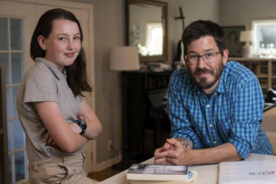 Jay Wamsted, right, and his daughter, Kira, are photographed on Thursday, May 20, 2021 in Smyrna, Ga. Wamsted, who is an 8th grade math teacher allowed his daughter to skip testing this year. With new flexibility from the Biden administration, states are adopting a patchwork of testing plans that aim to curb the stress of exams while still capturing some data on student learning. (AP Photo/Ben Gray)