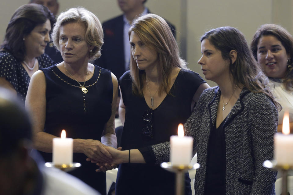 Pilar Nores, ex-wife of Peru's late President Alan Garcia, left, and their daughters, Josefina, center, and Luciana attend Garcia's wake at his party's headquarters in Lima, Peru, Thursday, April 18, 2019. Garcia shot himself in the head and died Wednesday as officers waited to arrest him in a massive graft probe that has put the country's most prominent politicians behind bars and provoked a reckoning over corruption. (AP Photo/Martin Mejia)