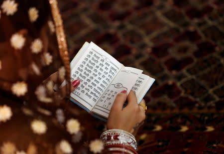 An Afghan Sikh woman prays inside a Gurudwara, or a Sikh temple, during a religious ceremony in Kabul, Afghanistan June 8, 2016. REUTERS/Mohammad Ismail