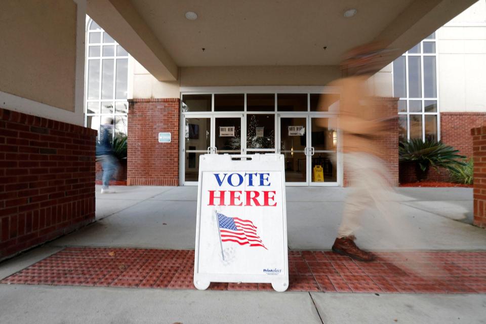 Voters flow in and out of Coastal Cathedral Curch on Tuesday December 6, 2022 during the runoff for U.S. Senate.