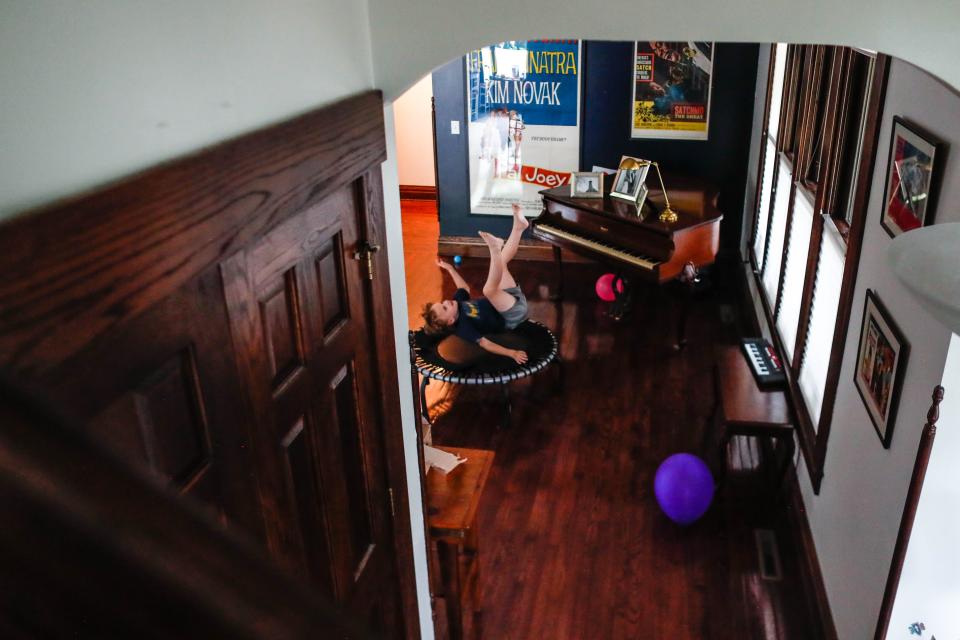 Michael Francis, 7, jumps on his trampoline in his home.