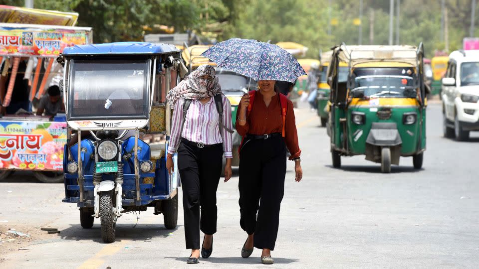People shield themselves from the summer heat in Gurugram, India on June 18, 2024. - Parveen Kumar/Hindustan Times/Getty Images