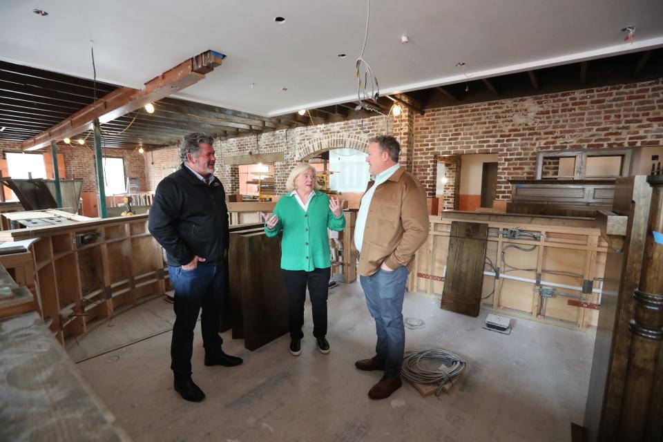 Tim Strickland, Jennifer Strickland, and Chris Swanson owners of the Wexford talk about the progress as they stand behind the bar that is currently being assembled on the 2nd floor of the Irish pub, located in City Market.